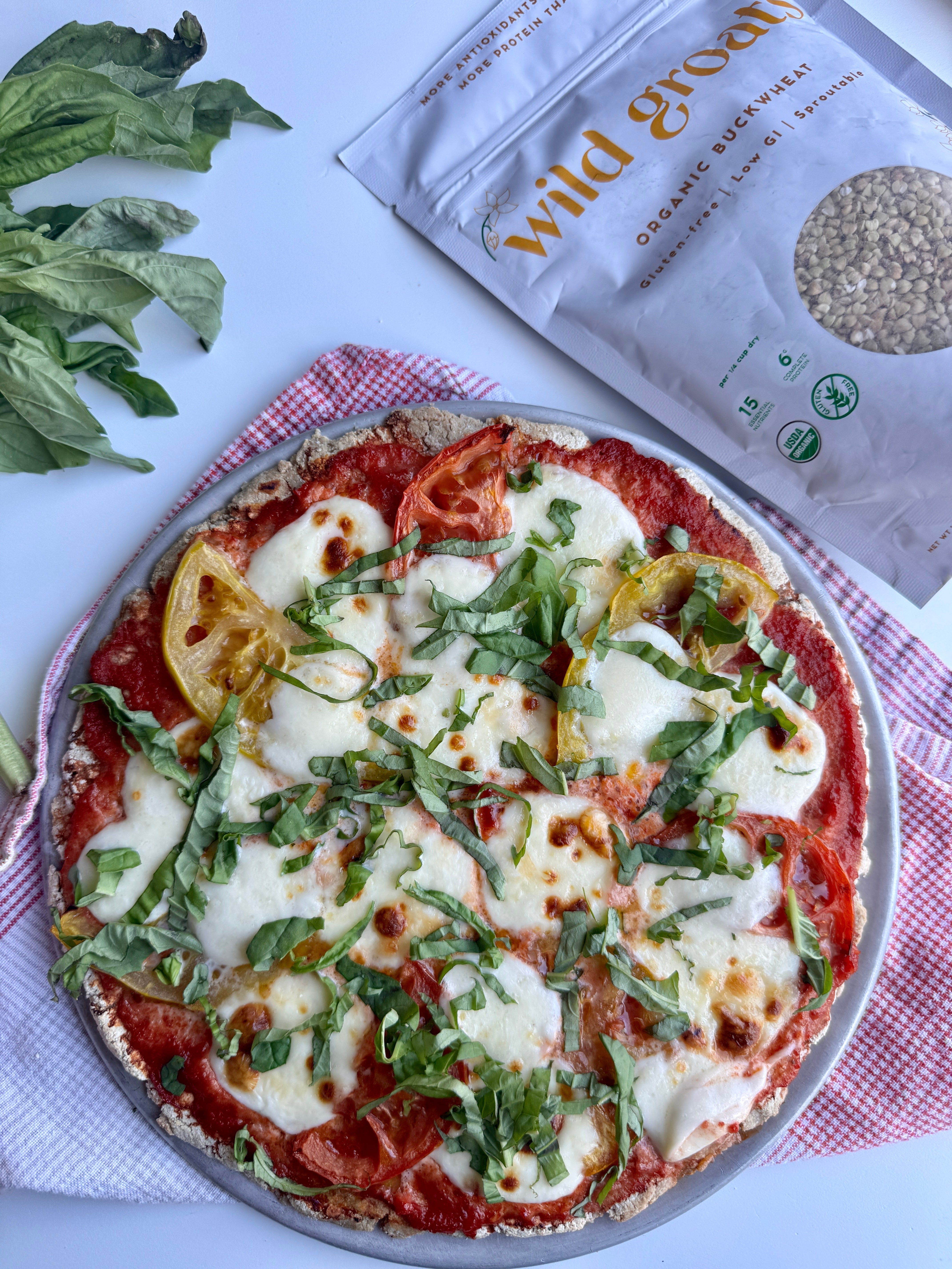 2-ingredient buckwheat pizza crust on a round pan, gluten-free and yeast-free, with crisp golden edges