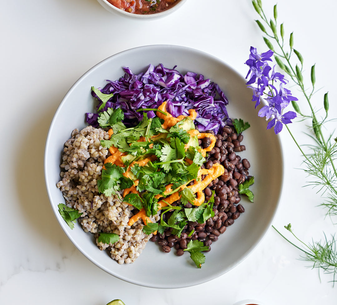 Burrito bowl with black beans, purple cabbage, buckwheat groats, cashew cheese and salsa