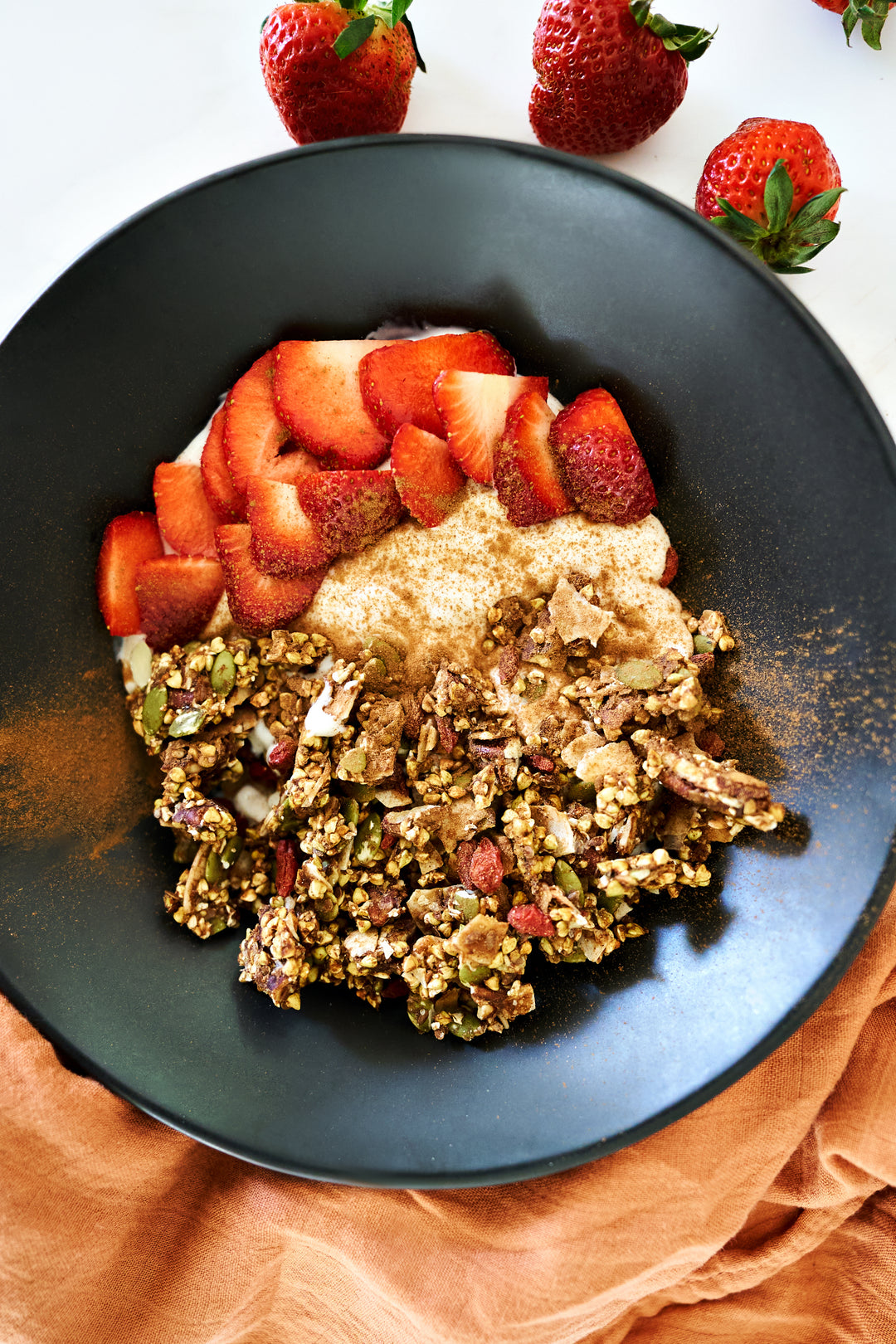 Raw buckwheat groats granola bowl with freshstrawberries 